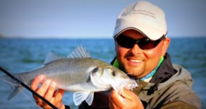 Bass fishing in Ireland A tanned Markus Muller with Bass